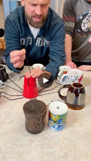 118K views · 2.4K comments | The Mug String Pull Game ☕️ | The Mug String Pull Game ☕️ Kids, Dad, and family play DIY party game with mugs and strings for candy and prizes. (for entertainment purposes only) | By Benson Bros | Facebook String Pull Carnival Game, Solo Cup Balloon Game, Easter Egg String Pull Game, Benson Bros, Diy Party Games, Balloon Games, Cup Games, Solo Cup, Easter Games