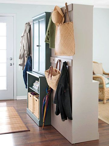 mudroom - Divide and Conquer  If your entry and living room are one and the same, divide the space with easy-to-assemble cabinetry. This nifty closet/room divider neatly organizes living room space into a hardworking entry. There's room for hanging coats and storing gear on one side and attractive display and storage space on the other. Hallway Storage Ideas, Temporary Room Dividers, Creating An Entryway, Metal Room Divider, Fabric Room Dividers, Glass Room Divider, Bamboo Room Divider, Sliding Room Dividers, Hanging Room Dividers