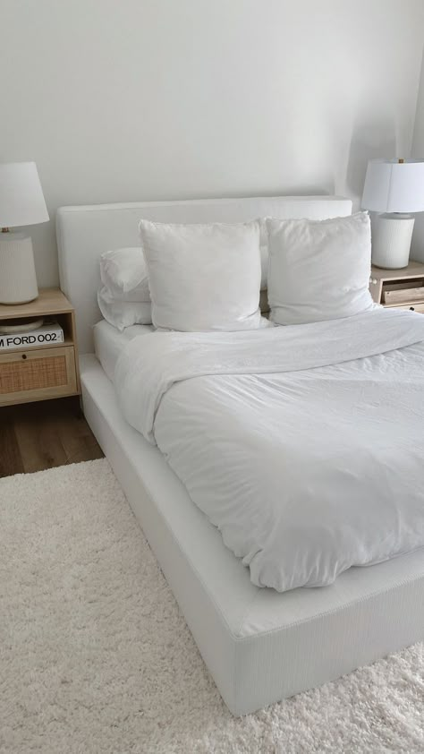 cloud couch, minimal bedroom, white bedroom, apartment ideas, interior design, minimal home, white bedding, nightstand, nightstand styling White Bedroom Rug Ideas, Low White Platform Bed, White Rug Under Bed, White Platform Bedroom Ideas, White Modern Apartment Decor, White Platform Bed Frame, White Basic Bedroom, Simple Clean Apartment Decor, White Cloud Bed Frame