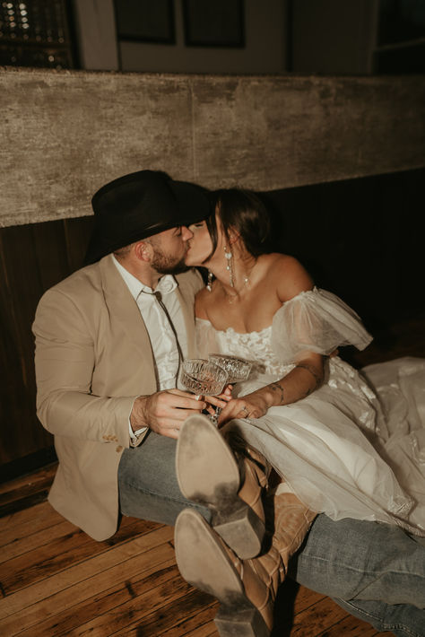 Country Western photo ideas, country wedding ideas, western wedding photo ideas, cowboy hat, cowboy boots wedding, wedding cowboy boots, wedding cowboy hat, flash photography, bar wedding photos, western wedding ideas, big wedding dress Wedding In Cowboy Boots, Cowboy Boots Wedding Photos, Wedding Dress With Boots Country, Cowboy Marriage, Western Wedding Detail Shots, Wedding With Boots, Wedding Ideas Big, Bar Wedding Photos, Wedding Cowboy Hat