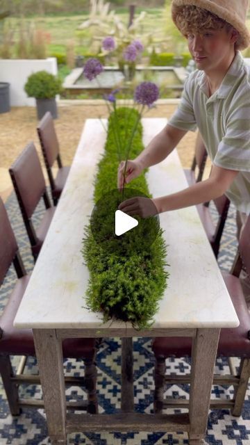 Jack kinsey [ Interior Design Masters ] on Instagram: "ad I’ve decided to try out Moss instead of Oasis for a change to take on the job of supporting this table arrangement 😍 what do you think?

 Seasonal flowers are giving VOGUE.

I LOVE creating tablescapes and floral arrangements using flowers that are in season as; A it’s budget-friendly, and B; it’s environmentally friendly!
These budget blooms included Chrysanthemums at £3 a stem, 5 Alliums for £7, 5 Hyacinths for £7 and a bunch of Statice for £6!

 They were from my local market in Norwich, @carysflowersltd a family-run business which I love to support 🌸 

 

#budgetblooms @howflowersdothat #cutflowers #tablescape #tablescapes #flowers #flower #arrangement #homedecor #ukhome" Moss Wedding Table, Oasis Flower Arrangements, Art In Bloom, Interior Design Masters, Table Arrangement, Uk Homes, Local Market, Seasonal Flowers, April 11