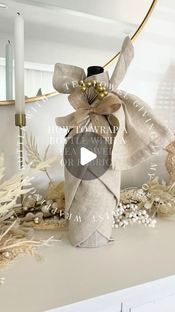 Wrap A Wine Bottle In A Tea Towel, Tea Towel Wine Bottle Wrap, Tea Towel Wrapped Gift, Gift Wrapping With Tea Towels, Wine Bottle Wrapped In Tea Towel, Gift Wrap Liquor Bottle Ideas, Wrapping A Wine Bottle In A Tea Towel, Wrap A Wine Bottle In A Dish Towel, Ways To Wrap Wine Bottles For Christmas