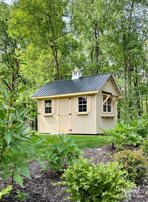 A wood backyard shed with black metal roof. I got a new shed this past week, and I couldn't be more excited. I just had to share it with you. Black Metal Roof, Goat Shed, Backyard Structures, Inspired By Charm, Craft Shed, Double Window, Outdoor Living Decor, Lawn Equipment, Backyard Shed