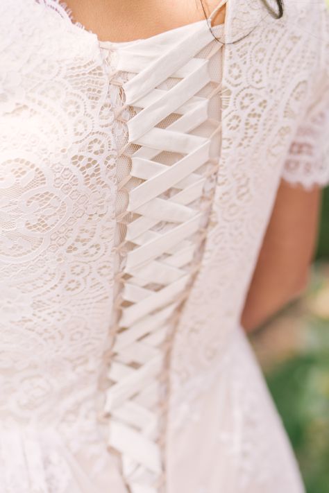 Close up details of lace up back wedding dress. Corset back wedding dress. Elizabeth Cooper Design modest wedding dress. Utah wedding photographer | Whitney Hunt Photography Wedding Dresses Lace Up Back, Lace Up Corset Back Wedding Dress, Corset Wedding Dress Vintage, Wedding Dress Corset Back, Lace Up Back Wedding Dress, Dress Corset Back, Pink And Burgundy Wedding, Fairy Bride, Corset Back Wedding Dress