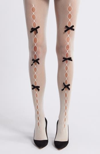 Delicate velvet bows detail the alluring oval openings on flirty fishnet tights designed with a high waist. Elastic waist Nylon Hand wash, dry flat Imported Coquette Tights, Tights With Holes, Tights With Bows, Skeleton Tights, Twee Fashion, Clue Costume, Bow Tights, Bow Cutout, Funky Tights