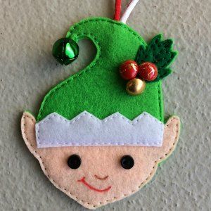 elf decoration made from felt and embellished with buttons Felt Elves Pattern, Felt Elf Pattern, Christmas Felt Crafts Free Pattern, Free Felt Christmas Ornaments Patterns, Felt Christmas Stockings Ideas, Felt Christmas Ornaments Templates, Xmas Stockings Ideas, Elf Decorations Christmas, Easy Christmas Paper Crafts