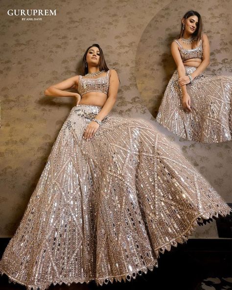 "Step into a world of ethereal beauty with this stunning silver shiny lehenga choli, a true testament to the artistry of ethnic fashion. The lehenga, adorned with exquisite embroidery, captures the light with its luminous sheen, creating a mesmerizing effect that is nothing short of magical. Each delicate stitch and intricate pattern is crafted with precision, reflecting a perfect blend of tradition and contemporary wear. Email : guruprem.socialmediateam@gmail.com Contact Us : +91 816978764... Shiny Lehenga, Geometric Lehenga, Champagne Lehenga, Mirrorwork Lehenga, Mirror Lehenga, Indo Western Lehenga, Champagne Mirror, Global Wedding, Gaun Fashion