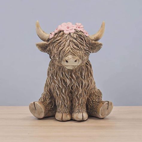 A cute resin Highland Cow ornament featuring pink flowers. Size 10cm x 8cm x 12cm PRE-ORDER - DUE IN END OF OCTOBER All orders containing pre-order items WONT BE POSTED OUT UNTIL ALL ITEMS ARE IN STOCK. Ceramic Animal Ideas, Highland Cow Sculpture, Ceramic Highland Cow, Highland Cow Clay Sculpture, Pottery Ornament Ideas, Animal Ceramics Ideas, Cute Animals Clay, Cow Ceramics, Highland Cow Clay