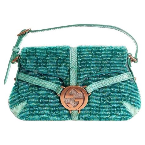 A Gucci signature piece in the famous GG Monogram Beautiful beaded turquoise bag with lizard trimmings Pink gold hardware with the Gucci siganture GG and tiny crystals Adjustable strap The beading is in the GG logo Fully lined Made in Italy Turquoise Bag, Lizard Skin, Gg Monogram, Luxury Purses, Pretty Bags, Gucci Handbags, Cute Bags, Vintage Bags, Fashion Handbags