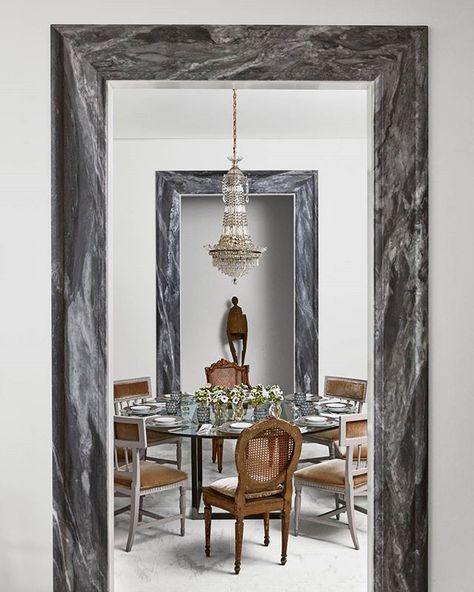 The marble door casing adds an elegant touch. | Photo: @loof39; Design: @johnoetgen #interiordesign #instahome #instadecor Marble Door Frame, Door Frame Interior, Marble Doorway, Dining Room With Round Table, Marble Door, Antique Interior Design, Veranda Magazine, Frame Interior, Marble Frame