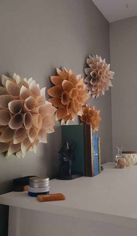 Add a charming touch to any space or event.  Dahlia style flower handmade out of vintage book paper. Measures 12" wide by 12" Tall. One flower included. It comes with a cotton backing and a twine loop to easily hang. This makes a beautiful addition to wall decor in any room... nursery, library, office, family room. They also make great additions to any party decor. Would make a beautiful photo wall or backdrop for your event. Is your bride a bookworm? Does your mama-to-be have a favorite book?   They can be made custom to incorporate a color or a book that may be special to you. Feel free to reach out with special requests. Rustic Paper Flowers, Book Paper Wall, Flowers Made From Paper, Book Paper Flowers, Nursery Library, Minimalist Embroidery, Paper Flowers Wall Decor, Paper Flower Wall Art, Hoop Wall Art