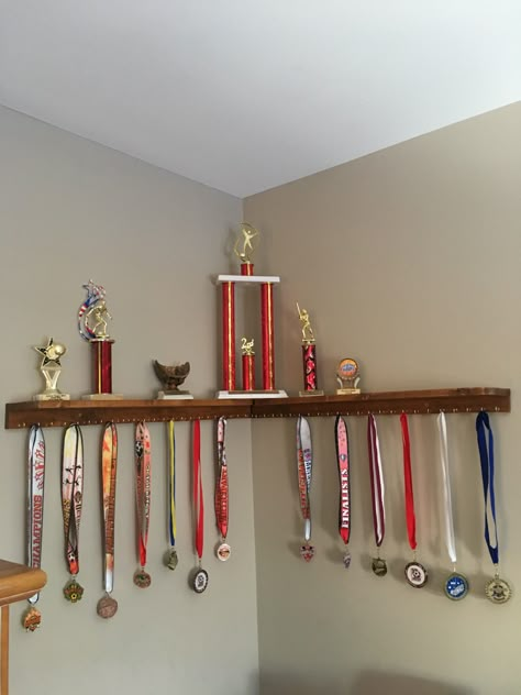 How To Display Trophies And Medals, Award Wall Display Ideas Bedroom, Ideas For Trophy Display, Award Shelf Display, Floating Shelf For Trophies, Trophy And Medal Display Ideas Shelves, Trophy Ribbon Display Ideas, Trophy And Metal Display Ideas, Medal Organizer Ideas