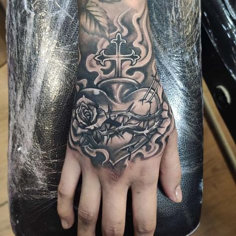 Heart of thorns hand tattoo Sacred Heart Tattoo, Rib Tattoos For Guys, Thorn Tattoo, Full Hand Tattoo, Sacred Heart Tattoos, Tato Henna, Rose Tattoos For Men, Hand And Finger Tattoos, Pretty Hand Tattoos