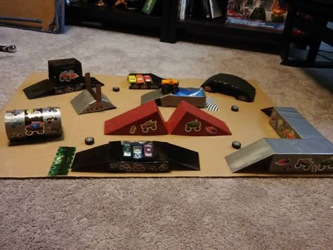 Monster Truck Course Diy, Monster Truck Arena Ideas, Diy Monster Truck Ramps, Diy Monster Truck Arena, Monster Truck Table, Monster Truck Diy, Cardboard Garage, Monster Truck Bed, Messy Party