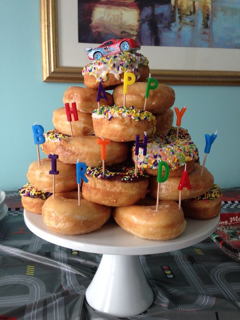 Birthday Doughnut Cake, Birthday Dessert Display Ideas, Krispy Kreme Donut Cake Birthdays, Birthday Donut Display, Dounat Birthday Cake, Doughnut Cake Birthday Tower, Donuts Cake Ideas, Donought Cake, Donuts For Birthday Party