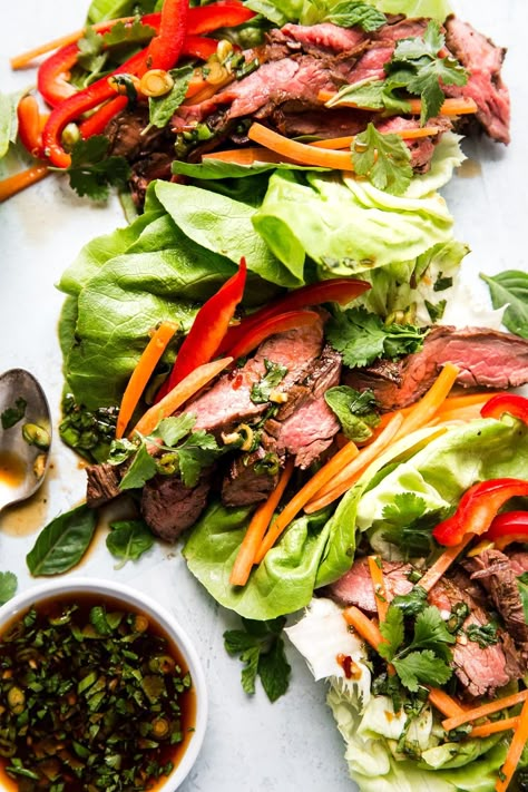 Steak is marinated in a dressing that sings with bright, zingy, Thai flavors, then seared and served in crisp lettuce cups in our beefed-up riff on the classic Laotian salad, Larb Gai. Dipping Sauce For Beef, Thai Wraps, Sauce For Beef, Thai Steak, Soy Ginger Sauce, Soy Ginger, Sara Foster, Steak Wraps, Beef Lettuce Wraps