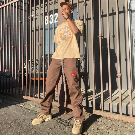 Travis Scott wearing Cacti Canvas Tan Hat, Cacti Heritage Work Brown Pants, Jordan Air Jordan 6 Retro British Khaki Sneakers. Jordan 6 Travis Scott Outfit, Jordan 6 Outfit, Travis Scott 6, Jordan 6 Travis Scott, Travis Scott Outfits, Travis Scott Fashion, Khakis Outfit, British Khaki, Mens Work Pants