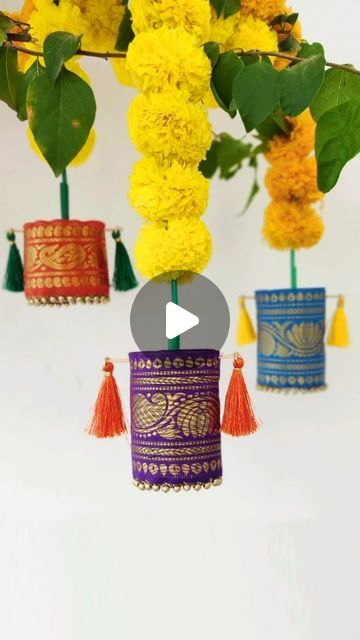 Rohini Deepthi Natti on Instagram: "#LetsGharGhar | Brocade ...let's call them Tassels?  Hubby called them Tibetan Prayer Rolls 😂   Here's next part of my Diwali decor. Fabric glue is yet to be delivered 😅 Refer to my previous reel for the brocade sleeve DIY. These silk tassels I bought are usually used for saree pallus.  Initial plan was to attach a thread but then poking sticks into it seemed more stable and easy. If you don't  have sticks, you could poke toothpicks from both ends and tape in between 😊  Satin ribbons or any fancy thread can be user to hang them instead of these garlands. Infact you can just hang them on curtain rods or trees like I did on my bougainvillea 😝  Hopefully by the time I finish making everything, LED diyas will arrive🤞Stay Tuned for the next part ❤️  #diw Diy Tassels Decoration, Fabric Tassel Garland, Diwali Craft Decoration, Diwali Hanging Decorations, Deepavali Decorations, Diwali Party Decor, Indian Decor Diy, Shadi Decor, Diwali Flowers