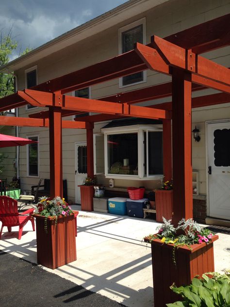 DIY PERGOLA: It took us (hubby and I) almost 5 months but we made this pergola using 2x4's, 6x6's, and 2x8's. The bases are planters and the uprights are cemented into them. Thank heaven for air wrenches! Otherwise don't know how we would've gotten the gigantic screws into the wood! We need to add a few details (additional top pieces for more shade, a bench, hooks for planters, etc) but the main structure is (finally) done! Overall very pleased! Pergola DIY Flower boxes Planters Backyard