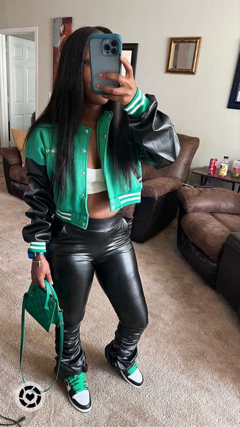 Girl standing in mirror wearing a green, black, and white cropped jacket, white crop top, and black stacked faux leather pants. She’s holding a green purse. Has on Nike Jordan 1 Lucky Green sneakers Jordan 1 Reverse Laney Outfit, Jordan Outfit Ideas Women, Air Jordan 1 Outfit Women Baddie, Jordan Outfit Women Baddie, Style Jordan 1 Women Outfit, Jeans And Jordans Outfit Women, Women Jordan 1 Fashion Styles, Dress With Jordan 1 Outfit, Outfits With Jordans Women