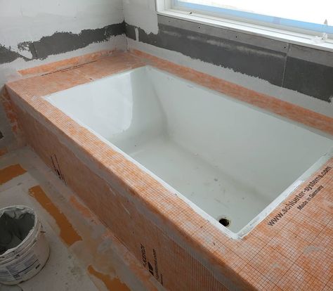 Our tile installer is prepping for an undermount tub that will sit in the shower.  We have always been huge fans of the kerdi system and it's a perfect fit for this situation. The top of the tub deck will be granite with a very slight slope to run the water off. All the walls of course will be covered in kerdi. • • • #kerdi #ditra #tile #tileinstaller #masterbath #bathroom #mastershower #homebuilder #homebuilding #customhome #farmhouse #devolbuilders Diy Drop In Tub Frame, Tiled Soaking Tub, Undermount Tub Deck, Inset Tub, Undermount Bathtub, Undermount Tub, Miami Bathroom, Custom Bathtub, Tile Tub