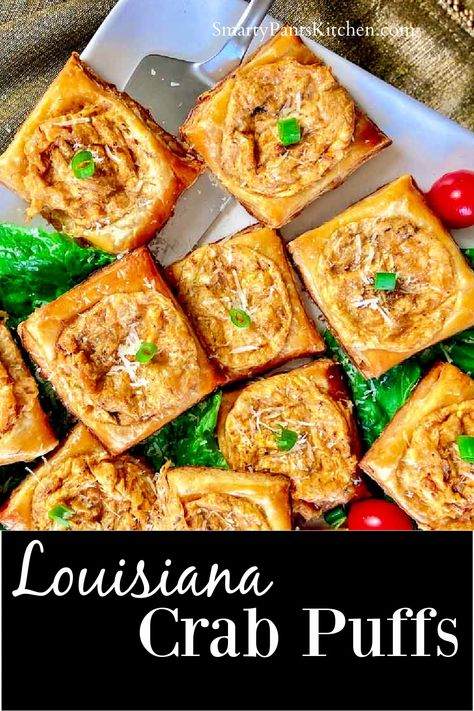 Squares of crab puffs on white plate garnished with cherry tomatoes and lettuce Crab And Puff Pastry, Crab Pastry Puff, Crab Puff Pastry Appetizers, Crab Puffs Recipe, Cajun Appetizers Louisiana Finger Foods, Canned Crab Recipes, Cajun Crab Dip, Cajun Appetizers, Crab Puffs