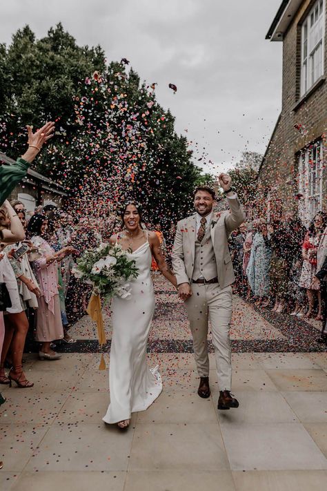 Colourful confetti photograph with bride in a satin wedding dress and groom in a beige three piece suit Satin Slip Wedding Dress, Confetti Wedding Photo, Flower Confetti Wedding, Confetti Wedding Exit, Back Garden Wedding, Wedding Group Photos, Slip Wedding Dress, Epic Love, Confetti Photos