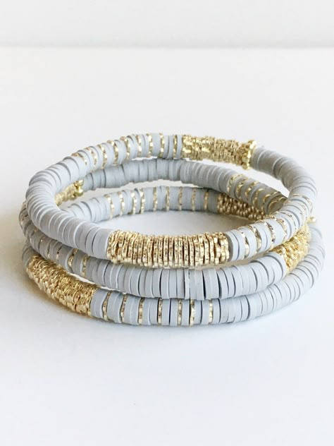 Light Gray Confetti and Gold Beaded Bracelet ⟡ all items are designed and handcrafted in our studio ⟡ Hand strung vinyl and 14kt gold plated beads on stretch material. Fun, lightweight, colorful bracelets - perfect for year round. A combination of polymer clay vinyl beads and 14kt gold plated beads. Each bracelet is stretchable and easily layers with other bracelets or a watch. The bracelet cannot be opened, and need to fit over your hand. Treat yourself to a fun new bracelet! These bracelets ar Polymer Clay Beaded Bracelet, Clay Bead Patterns Bracelet, Clay Beads Jewelry Making Tools, Gray Clay Bead Bracelet, Clay Bead Bracelet Ideas Neutral Colors, Polymer Clay Bead Jewelry, Hieshi Clay Bracelets, Trendy Bracelets 2023, Heishi Bracelet Ideas Fall