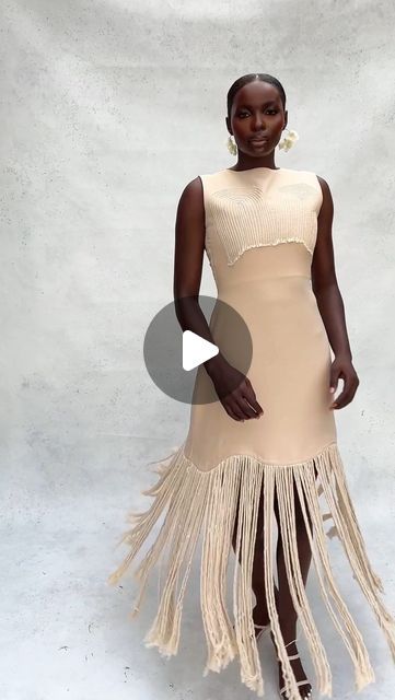 Knanfe Fashion on Instagram: "The Buzu Dress is an elegant modern, sleeveless, form-fitting beige dress with a unique tribal-inspired design. 

The top features textured fabric with subtle tribal marks, while the bottom has a flowy cut and a fringe skirt detail from mid-thigh down, creating a striking visual contrast. 

The neutral beige color makes it versatile and sophisticated, perfect for both formal and semi-formal events. The dress comes complete with a matching blazer, adding a touch of elegance to this already-stunning outfit. 

Fabric: Crepe." Fringe Dress Formal, Photoshoot Idea, Beige Dress, Fringe Skirt, Beige Dresses, Stunning Outfits, Neutral Beige, Photoshoot Outfits, Textured Fabric