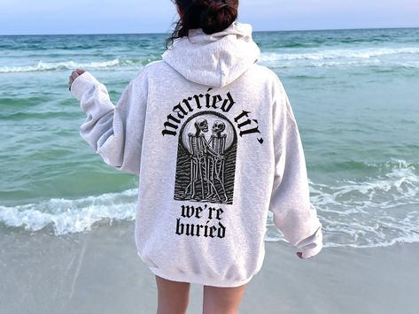 Goth Wedding Sweatshirts, Married Til' We're Buried Shirt, Engaged Gift Gothic Shirt, Bride Halloween Wedding Gift, Bridal Shower Gift,D6746 H O W  TO  O R D E R 1️⃣Please, check and review all the photos. 2️⃣ Choose your T-shirt size and color. 🔵Different styles of shirts may have different shades of same color choice due to different manufacturer brands. 🔵For this reason, we recommend you to match shirts from the same styles if you want precisely matching colors (ex. Unisex, V-necks, Toddler Goth Engagement, Wedding Hoodie, Halloween Wedding Gifts, Wedding Sweatshirts, V Neck Shirts, Gothic Shirts, Goth Wedding, Dark Wedding, Wedding Shirts