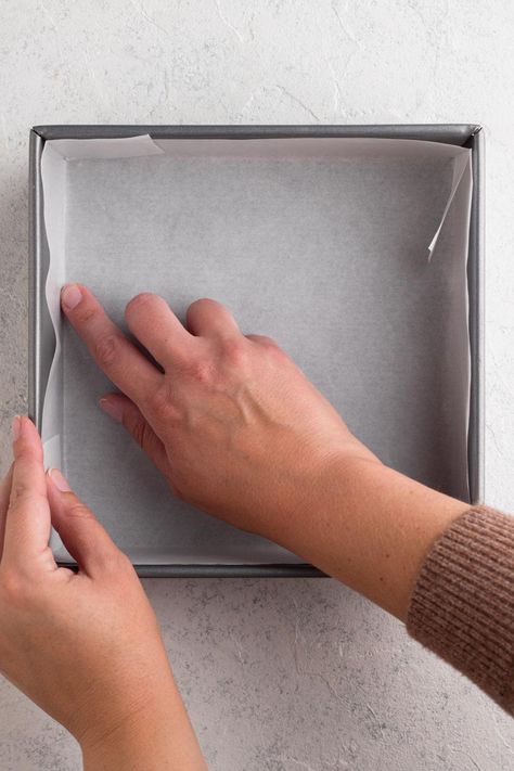 Have you ever wondered what's the best way to line pans with parchment paper? What's the easiest way to line square and rectangular pans? And what about round cake pans? In this article I'm sharing all of my tips - including detailed instructions and a video - for how to easily line baking pans of all different shapes and sizes with parchment paper. How To Line A Pan With Parchment Paper, How To Line A Cake Pan With Parchment, How To Line A Square Pan With Parchment, How To Fold Parchment Paper For Cake Pan, Baking Conversions, Bakers Kitchen, Parchment Paper Baking, Baking Videos, Square Pan