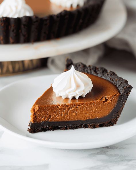 Decadent Dark Chocolate Pumpkin Tart Get ready to elevate your fall dessert game with this rich and decadent Dark Chocolate Pumpkin Tart. It combines a silky pumpkin filling with a ... Read more Chocolate Pumpkin, Pumpkin Pie With Chocolate Crust, Pumpkin Chocolate Pie, Taste Of Lizzy Pumpkin Pie, Pumpkin Caramel Tart, Millionaire Pumpkin Tart, Dark Chocolate Pumpkin Tart, Pumpkin Cheesecake With Chocolate Crust, Chocolate Pumpkin Tart