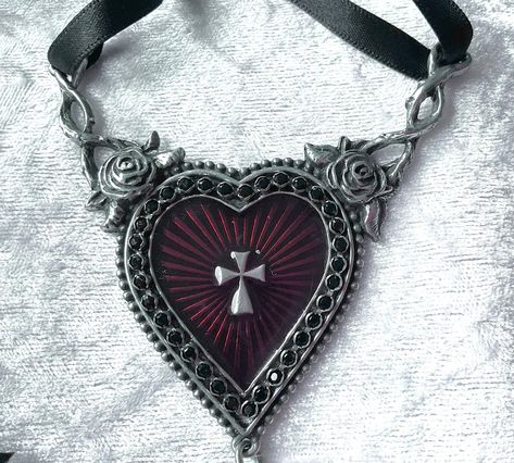 A splendour of Swarovski crystals and enamel encrust this lavish icon to the suffering. A dramatic piece for the romantic at heart. A large pewter heart pendant with translucent red enamelled sunburst centre. Finished with a black Swarovski crystal dropper. Made by Kiss of a red rose with inspiration from Alchemy Gothic. The choker comes with a red velvet gift pouch. Claire Core, Alchemy Gothic, Gothic Pendant, Dark Jewelry, The Sacred Heart, Heart Choker, Rose Rouge, Gift Pouch, Crystal Necklace Pendant