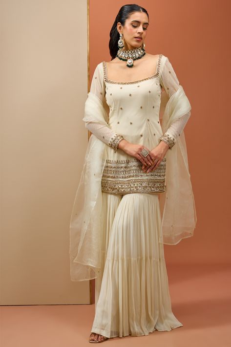 Off-white kurta and sharara in georgette with a hand embroidered neckline and hemline paired with an organza dupatta Sharara Designs Simple, Sharara Designs For Wedding, Net Sharara, Garara Dress, Sarara Dress, Flared Sharara, Velvet Kurti, Indowestern Dresses, Kurta And Sharara