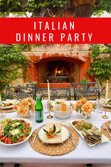 A beautiful dinner party set-up for 6 to 8 people. The table is set with a white linen table cloth in front of a rustic outdoor fireplace. On the table there is an antipasto platter and a large salad with burrata and tomatoes. The table setting includes peach-colored roses and gold candlestick holders with ivory taper candles. Italian Dinner Menu, Italian Dinner Table, Italian Food Party, Italian Dinner Party Decorations, Italian Food Menu, Vegetarian Dinner Party, Party Entrees, Birthday Dinner Menu, Dinner Party Ideas