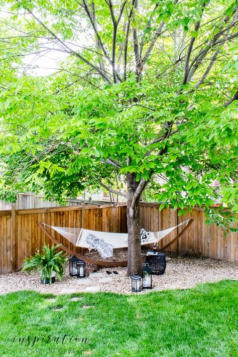 Turn an area of your yard into a backyard hammock oasis escape. It's the perfect way to enjoy the lazy days of summer. #summeroutdoordecor #hammocklife Hammock Corner Backyards, Hammock In Corner Of Yard, Hammock Ideas Backyard Trees, Hammock Nook Outdoor, Tree Hammock Ideas, Dirt Area In Backyard, Hoa Friendly Backyard, Backyard Hammock Oasis, Hammock Under Tree