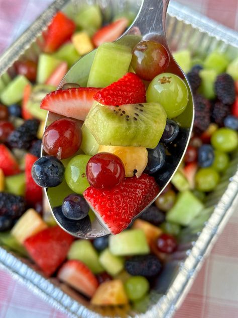 Long handled silver serving spoon with freshly chopped mixed fruit being lifted above a pan full of fruit salad that was made a day ahead of time for a crowd at a party. Easy Fruit Salad For Party, Easy Fruit Salad Recipes Simple, Make Ahead Fruit Salad, Fruit Salads For Parties, Fruit Salad For A Crowd, Salad For A Crowd, Breakfast Fruit Salad, Easy Fruit Salad Recipes, Best Fruit Salad