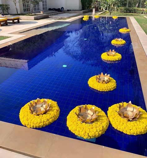 15 Unique Ways to Decorate the Pool & Poolside Area at Your Wedding Venue | ShaadiSaga Haldi Decor Poolside, Poolside Mehendi Decor, Haldi Pool Decor, Poolside Haldi Decor, Pool Side Haldi Decor, Haldi Entry, Marigold Flower Garland, Swimming Pool Decorations, Color Home Decor