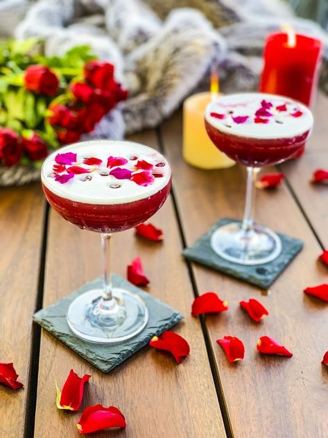 Love Potion #9, the perfect date night cocktail. Our take on a gin sour, this drink has gin, lemon juice, simple syrup, pomegranate juice and rose petals. It will make that date night or Valentine's Day super special.   #romantic #cocktails #cocktailrecipes #cocktaildrinks #cocktailarts #valentines #valentinesday #valentinesdayideas #valentinesdayparty #valentinesdayfood #datenightmenu #datenightideas #gincocktails Valentines Cocktails Drink Recipes, Pomegranate Gin, Romantic Cocktails, Valentine Drinks, Valentine Cocktails, Gin Sour, Gin Lemon, Valentines Day Food, Champagne Cocktail