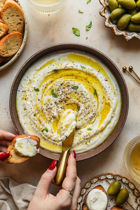 This lemony whipped ricotta dip is easy, creamy, and comes together in about 5 minutes! This Italian-inspired appetizer is by far one of my favorite recipes with ricotta cheese. Simply top it with olive oil and black pepper or try other toppings like hot honey, pistachios, balsamic glaze, olives, and more. This homemade dip is an amazing party snack for summer time or even winter holidays like Thanksgiving and Christmas. This recipe is one of my go-to snacks for parties, holidays, and more! Ricotta Dip Recipes Appetizer Ideas, Ricotta Dip Recipes, Recipes With Ricotta, Recipes With Ricotta Cheese, Whipped Ricotta Dip, Super Easy Dips, Frozen Pudding, Ricotta Dip, Ricotta Cheese Recipes