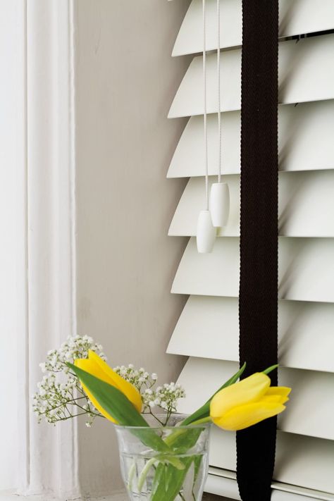 Close-up of white wooden blinds with contrasting black ladder tapes White Faux Wood Blinds, Wooden Venetian Blinds, Lavish Living Room, Best Blinds, White Wooden Blinds, Faux Wood Blinds, Fitted Blinds, Night Blinds, Perfect Fit Blinds