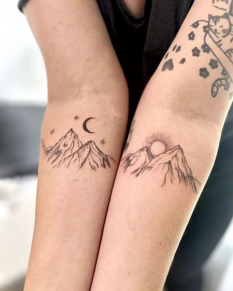 Mountain tattoos capture nature's majesty through rugged body art. These scenic designs feature peaks, ranges, and alpine landscapes. Popular mountain tattoo ideas include geometric outlines, detailed landscapes, and minimalist silhouettes. Mountain ink styles range from realistic depictions to abstract interpretations. Tattoos with mountains symbolize strength, adventure, and personal growth, often incorporating elements like trees, wildlife, or starry skies. Adventure Buddy Tattoos, Matching Mountain Tattoos For Best Friends, Slightly Matching Tattoos, Ain't No Mountain High Enough Tattoo, Matching Adventure Tattoos, White Mountain Tattoo, Matching Nature Tattoos Couples, Mountain Northern Lights Tattoo, Mountain Tattoo For Couples