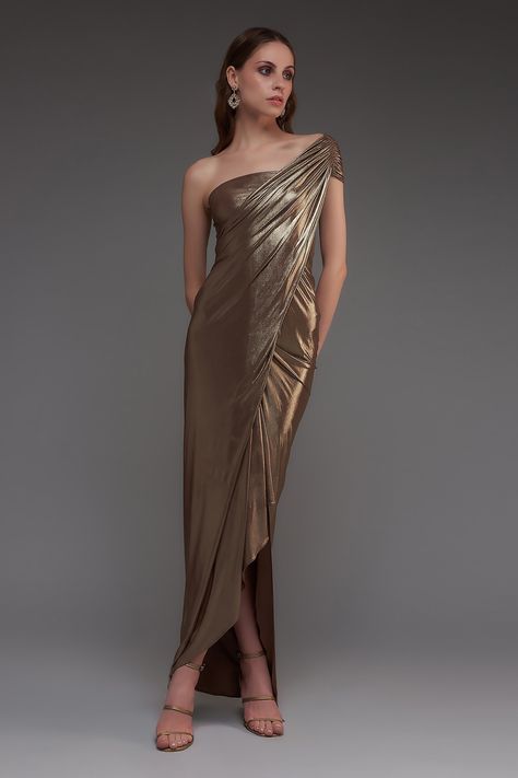 Buy Brown Stretch Knit Foil Solid Metallic One Shoulder Draped Gown For Women by Cham Cham Online at Aza Fashions. Gold Dress Metallic, Metallic Evening Gown, Bronze Evening Dress, Drape Dresses Western, Molten Metals Bridesmaids, Bronze Wedding Dress, Metallic Wedding Dress, Bronze Gown, Drape Dresses