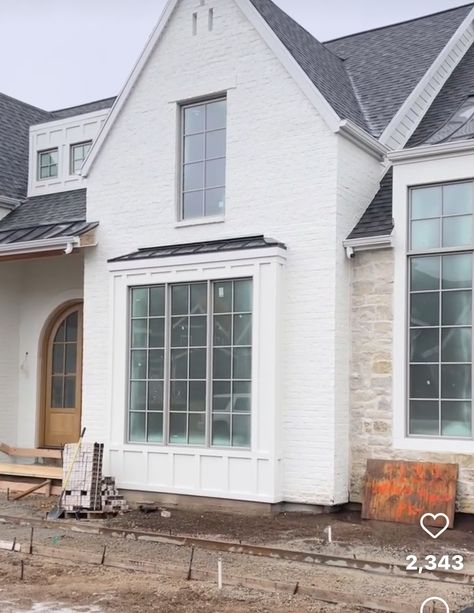 Home With Bay Window Exterior, White Brick With Stone Exterior, Cream Stone House Exterior, White Stone And Brick House Exterior, Stone And Painted Brick House Exterior, All Stone House Exterior, White Siding And Stone Exterior, Tan Windows Exterior, White Stone House Exterior