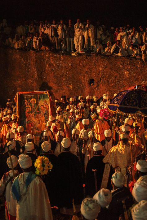 Ethiopian Orthodox Christmas, known as *Genna*, is celebrated with profound devotion in Lalibela, Ethiopia. Pilgrims gather in this holy city, famous for its rock-hewn churches, to participate in all-night prayers, hymns, and liturgical services. The celebration is marked by traditional chants, candlelight processions, and a deep sense of spiritual reverence, creating a truly awe-inspiring atmosphere. #Orthodoxtewahdo #Orthodoxchristmas #Sacredlalibela Ethiopia Orthodox Wallpaper, Ethiopian Orthodox Hosanna, Ethiopian Orthodox Aesthetic, Ethiopian Orthodox Wallpaper, Ethiopian Christmas, Ethiopia Aesthetic, Habesha Aesthetic, Ethiopian Iconography, Ethiopian Orthodox Tewahedo Wallpaper