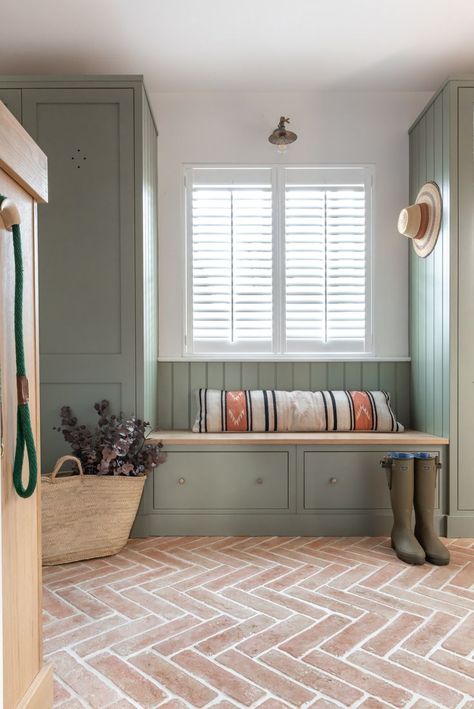 The boot room is a joy of simple function and pared back design, featuring the the gorgeous warm terracotta brick slips flooring which adds a rustic warmth while complementing the natural textures wonderfully and cupboards in a dark grey-green. It has plenty of storage for footwear and coats as well as a bench to sit on with drawers beneath for gloves, hats and scarves. Stone Floor Laundry Room, Mediterranean Style Bathroom, Indoor Tiles, Complete House Renovation, Hallway Tiles, Terracotta Floor Tiles, Orange Tiles, Brown Shade, Brick Flooring