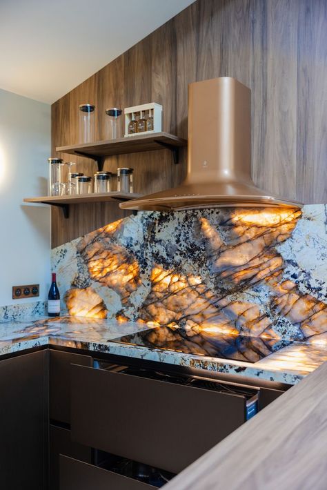 Backlit stone backsplash Onyx countertops Warm-tone kitchen design Copper range hood Luxury kitchen design Onyx Countertop, Backlit Stone, Onyx Kitchen, Onyx Countertops, Copper Range, Copper Range Hood, Stone Backsplash, Backsplash Kitchen, Luxury Kitchen Design