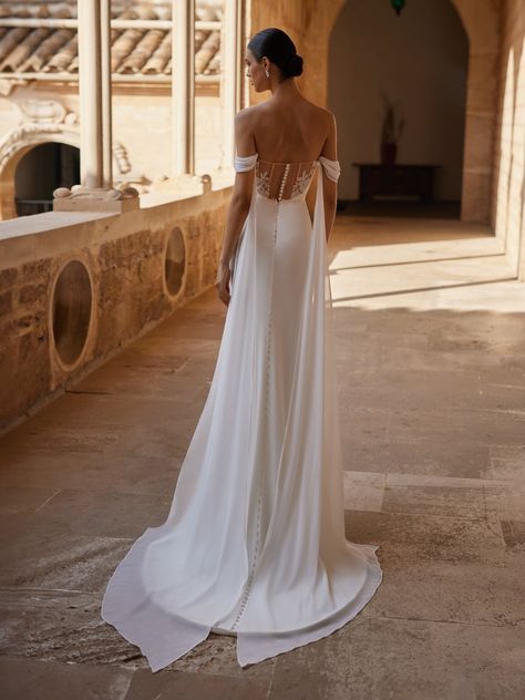 Bring your wedding day dreams to life with the Moonlight Tango T123 wedding dress. In a figure-flaunting mermaid silhouette, this gown boasts a soft, romantic look in crepe back satin with net illusion on the back. Fitted through the bodice and hips, this design features a strapless bodice with a sweetheart neckline, off the shoulder swag sleeves with long chiffon tails that drape down the back, and a sheer back bodice with tattoo lace. The back is embellished with embroidered lace appliques ... Slim Wedding Dresses, Grecian Wedding Dress, Grecian Wedding, Moonlight Bridal, Tail Dress, Bridal Gowns Mermaid, Back Wedding Dress, Embroidered Wedding, Romantic Look