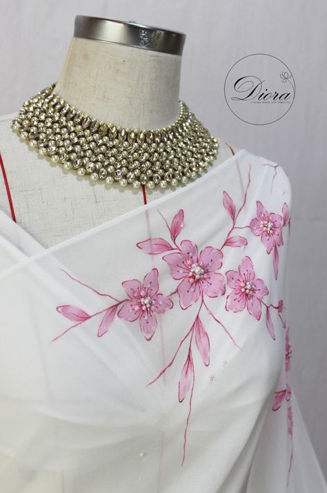 #diora #dioraembroidery #dioraapparel #details  #handpaintingsaree #embelishment #handembroidery #designersaree #engagement #engagementbride #bridalsaree  #designerdress #uniquebeauty #elegance #Emergingbrand #2022yearendparty #simplicity  #christmas2022 #yearendwedding #december  #decemberwedding #pinkflowers #flowers #2023calendar #2023weddings  #fairytalewedding #fairytale #srilankanweddings #srilankanbrides #srilankansarees Fabric Colour Painting, Fabric Paint Shirt, Saree Painting Designs, Saree Painting, Floral Logo Design, Fabric Painting Techniques, Hand Painted Dress, Fabric Painting On Clothes, Dress Painting