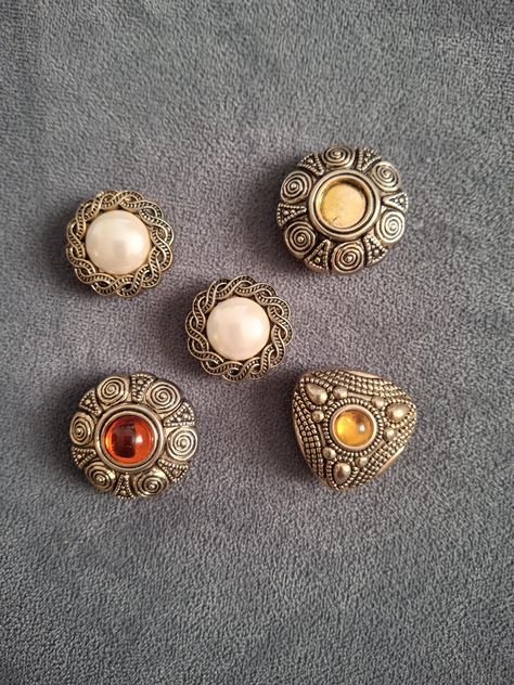 Set of five Vintage button covers, detachable button clips Designed to be worn over existing buttons Various shapes including floral and pearl embellishments and intricate metal work Button Covers, Vintage Button, Metal Work, Covered Buttons, Metal Working, Embellishments, Craft Supplies, Floral, Design